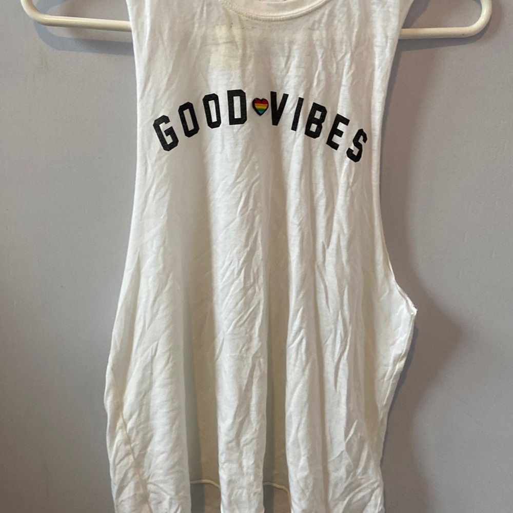 Spiritual Gangster white muscle tee with “Good Vibes”.